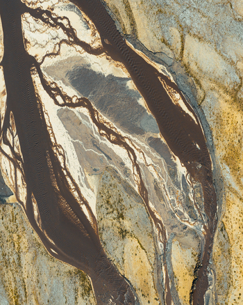 Aerial view of a braided river system with dark sediment rich water flowing through sandy banks and post industrial terrain in Konin Greater Poland Voivod Poland. Aerial view of a braided river system with dark sediment rich water flowing through sandy banks and post industrial terrain in Konin Greater Poland Voivod Poland.