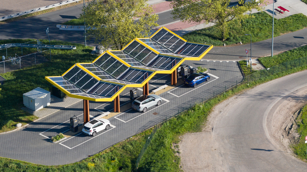 Zwolle Netherlands 23 April 2026 Aerial view of Fastned Charging Station with solar panel roof and electric cars parked underneath. Zwolle Netherlands 23 April 2026 Aerial view of Fastned Charging Station with solar panel roof and electric cars parked underneath.