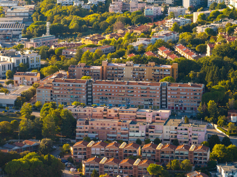 Aerial view of residential apartment buildings surrounded by lush green trees and urban landscape in Ancona Marche Italy. Aerial view of residential apartment buildings surrounded by lush green trees and urban landscape in Ancona Marche Italy.