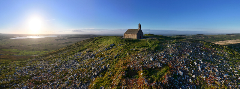 Aerial view of Chapelle Saint Michel de Brasparts on a rocky hilltop overlooking the Monts d Arree landscape at sunset in Saint Rivoal Bretagne France. Aerial view of Chapelle Saint Michel de Brasparts on a rocky hilltop overlooking the Monts d Arree landscape at sunset in Saint Rivoal Bretagne France.