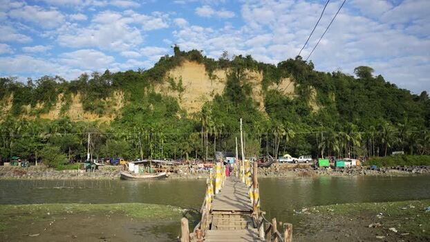 View of a wooden bridge and lush hills in Cox s Bazar Bangladesh.