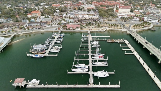 Aerial view of the St. Augustine Municipal Marina with docked sailboats and the Bridge of Lions spanning the Matanzas River in St. Augustine Florida United States.