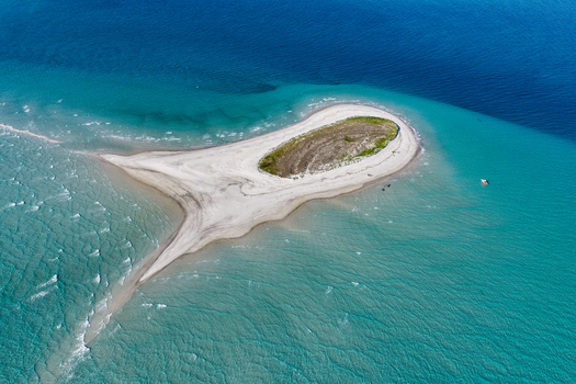 Aerial view of Pelican Bank featuring a white sandbar surrounded by turquoise and deep blue ocean waters in K gari Queensland Australia. Aerial view of Pelican Bank featuring a white sandbar surrounded by turquoise and deep blue ocean waters in K gari Queensland Australia.