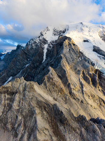 Aerial view of Payer Hutte at Ortler Mountain featuring rugged rocky ridges snow capped peaks and dramatic alpine terrain in Sulden Trentino Alto Adige Italy. Aerial view of Payer Hutte at Ortler Mountain featuring rugged rocky ridges snow capped peaks and dramatic alpine terrain in Sulden Trentino Alto Adige Italy.