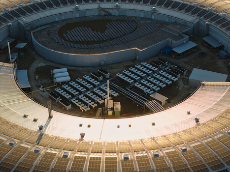 Aerial view of Diamond Light Source a circular synchrotron facility surrounded by greenery under golden hour light in Didcot United Kingdom.