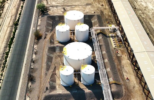 Grand Junction Colorado United States 03 July 2026 Aerial view of industrial storage tanks at a facility featuring white cylindrical tanks connecting pipelines and gravel ground. Grand Junction Colorado United States 03 July 2026 Aerial view of industrial storage tanks at a facility featuring white cylindrical tanks connecting pipelines and gravel ground.