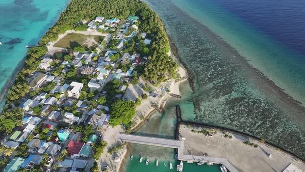 Aerial view of Fulhadhoo island village and coral reefs Maldives. Aerial view of Fulhadhoo island village and coral reefs Maldives.