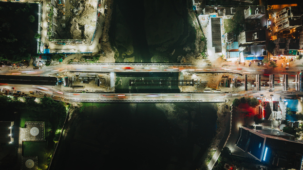 Aerial view of a bridge over a river at night with light trails from traffic in Chennai Tamil Nadu India.