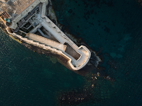 Aerial view of the historic Castello Maniace on the Island of Ortigia surrounded by the deep blue Mediterranean Sea in Syracuse Sicily Italy. Aerial view of the historic Castello Maniace on the Island of Ortigia surrounded by the deep blue Mediterranean Sea in Syracuse Sicily Italy.