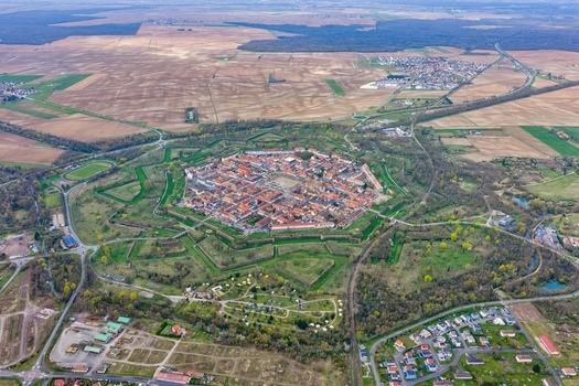 Aerial view of the star shaped fortress city a mesmerizing blend of rust colored rooftops and verdant moats stands as a testament to history Neuf Brisach Grand Est France.