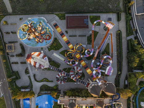Aerial view of a vibrant water park featuring colorful water slides winding flumes and swimming pools surrounded by green landscaping in Bulgaria. Aerial view of a vibrant water park featuring colorful water slides winding flumes and swimming pools surrounded by green landscaping in Bulgaria.