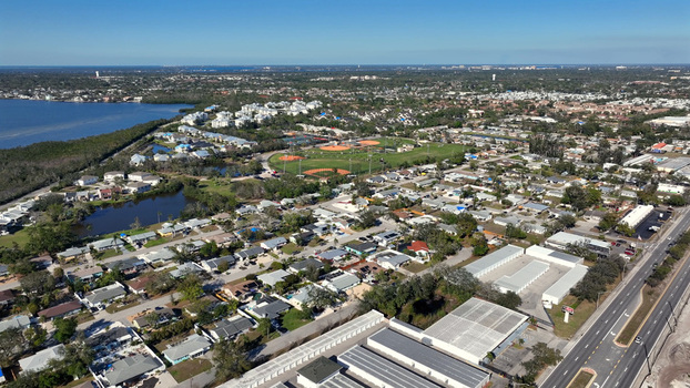 Aerial view of residential neighborhoods a baseball complex a small lake and a highway in Bradenton Florida United States.