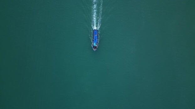 Aerial view of a boat cruising in the sea Indonesia.