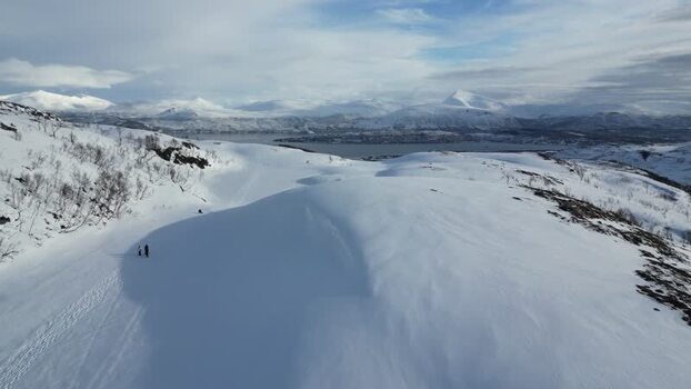 Aerial view of snowy mountains and Kvaloya island in Norway.