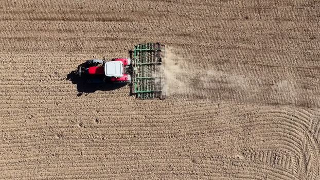 Aerial view of tractor tilling the land France.