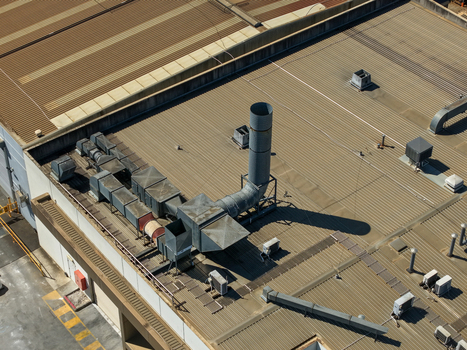 Aerial view of industrial rooftop featuring ventilation ducts exhaust pipes and machinery on a corrugated metal roof in Kilsyth Victoria Australia. Aerial view of industrial rooftop featuring ventilation ducts exhaust pipes and machinery on a corrugated metal roof in Kilsyth Victoria Australia.
