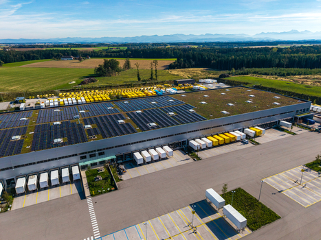Aerial view of the Logistikzentrum Allhaming logistics center with rooftop solar panels loading docks and trucks in Allhaming Oberosterreich Austria. Aerial view of the Logistikzentrum Allhaming logistics center with rooftop solar panels loading docks and trucks in Allhaming Oberosterreich Austria.
