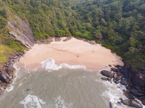 Aerial view of secluded butterfly beach on a bright sunny day in south of goa India.