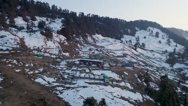 Aerial view of Chopta Tungnath settlement on snowy slopes India.