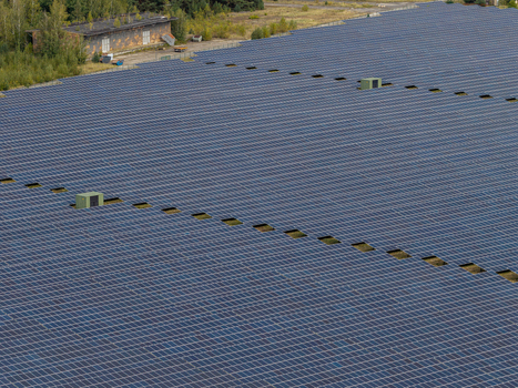 Aerial view of the solar field at the former military airfield in Preschen with historic hangars and rows of solar panels in Neisse Malxetal Brandenburg Germany. Aerial view of the solar field at the former military airfield in Preschen with historic hangars and rows of solar panels in Neisse Malxetal Brandenburg Germany.