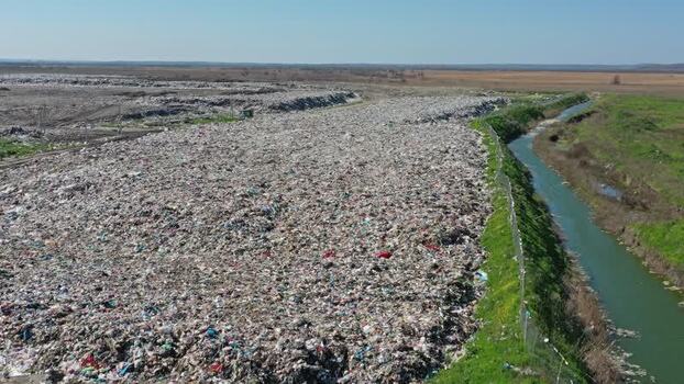 Aerial view of large landfill site next to a river Russia.