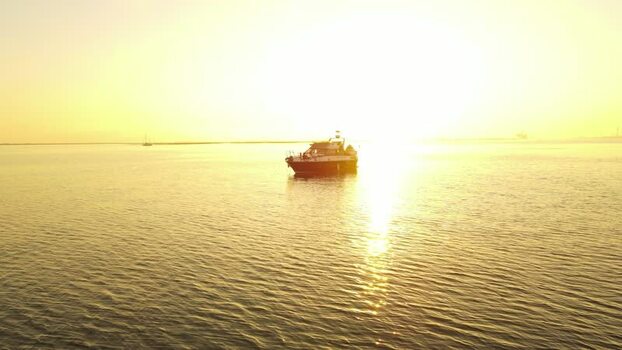 Aerial view of a boat on calm water at sunset France. Aerial view of a boat on calm water at sunset France.