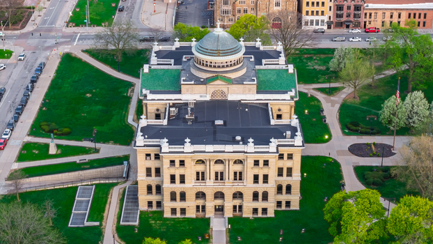 Toledo Ohio United States 10 July 2026 Aerial view of the Lucas County Courthouse featuring its prominent dome and green roof surrounded by manicured lawns and urban streets.