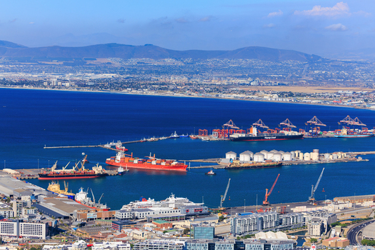Aerial view of the vibrant harbor speckled with ships and cranes against the backdrop of Table Mountain Cape Town Western Cape South Africa.