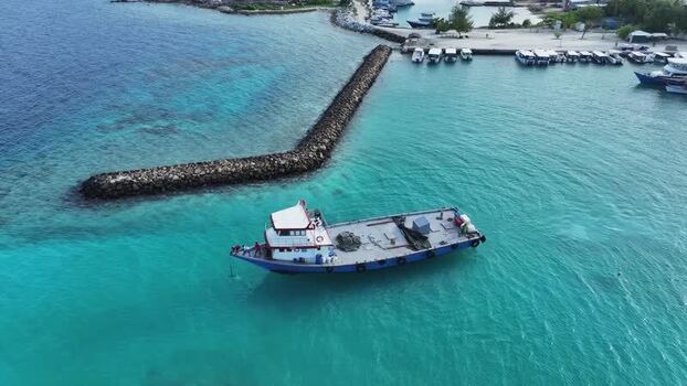 Aerial view of a boat leaving the harbour of Gulhi Kaafu Atoll Maldives. Aerial view of a boat leaving the harbour of Gulhi Kaafu Atoll Maldives.