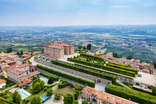 Aerial view of the historic Castello di Guarene with its manicured Italian gardens and the surrounding rolling hills of the Langhe region in Guarene Piedmont Italy. Aerial view of the historic Castello di Guarene with its manicured Italian gardens and the surrounding rolling hills of the Langhe region in Guarene Piedmont Italy.