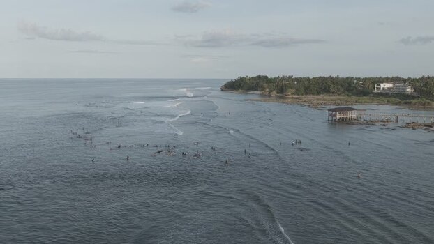 Aerial view of surfers at Cloud 9 on Siargao Island Philippines.