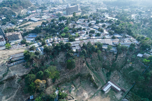 Chittagong Bangladesh 10 March 2022 Aerial view of a hillside settlement with dense housing and vegetation situated on steep terrain prone to landslides.
