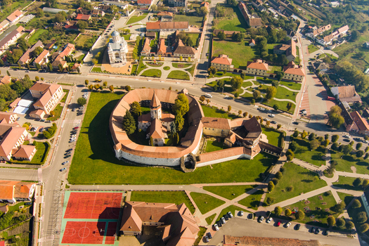 Aerial view of the historic Prejmer Fortified Church with its circular defensive walls and central sanctuary surrounded by green lawns and the town of Prejmer Brasov Romania. Aerial view of the historic Prejmer Fortified Church with its circular defensive walls and central sanctuary surrounded by green lawns and the town of Prejmer Brasov Romania.