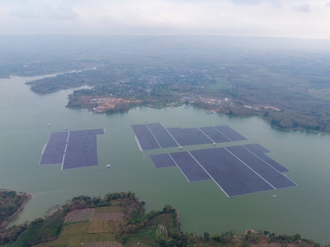 Aerial view of the floating solar power plant on Sutami Dam featuring large arrays of photovoltaic panels on the water in Kecamatan Sumberpucung Jawa Timur Indonesia. Aerial view of the floating solar power plant on Sutami Dam featuring large arrays of photovoltaic panels on the water in Kecamatan Sumberpucung Jawa Timur Indonesia.