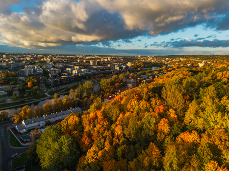 Aerial view of the city s skyline meets the golden hues of autumn foliage near the river a tapestry woven under a dramatic sky Vilnius Lithuania. Aerial view of the city s skyline meets the golden hues of autumn foliage near the river a tapestry woven under a dramatic sky Vilnius Lithuania.