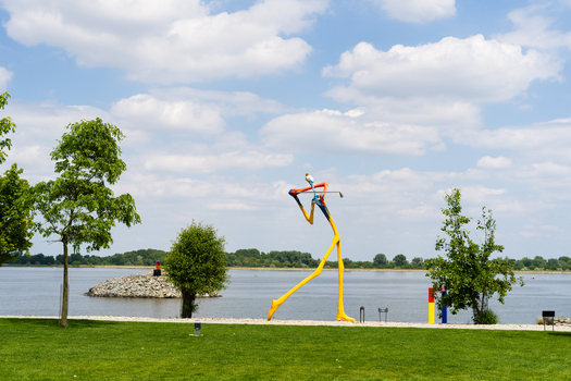 Bratislava Slovakia 09 May 2026 View of a large colorful abstract golfer sculpture on a green lawn by the Danube river at the Danubiana Meulensteen Art Museum.