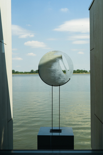 Bratislava Slovakia 09 May 2026 View of a circular modern sculpture at the Danubiana Meulensteen Art Museum overlooking the Danube river under a blue sky.