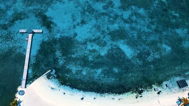 Aerial view of a wooden pier and turquoise waters in Guanaja Honduras.