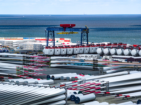 Aerial view of the Siemens Gamesa Renewable Energy facility in Cuxhaven featuring rows of wind turbine blades and nacelles stored near the North Sea Cuxhaven Niedersachsen Germany.