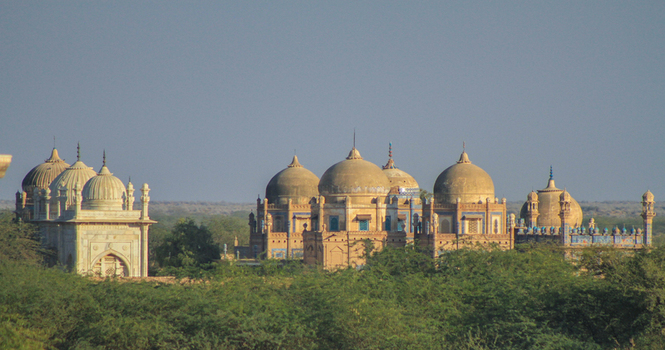 View of the historic Abbasi family tombs with their distinctive domes and intricate blue tile work set against the arid landscape of the Cholistan Desert in Bahawalpur Punjab Pakistan. View of the historic Abbasi family tombs with their distinctive domes and intricate blue tile work set against the arid landscape of the Cholistan Desert in Bahawalpur Punjab Pakistan.