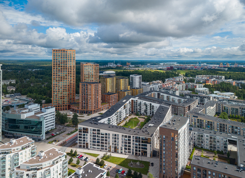 Aerial view of modern residential apartment buildings and high rise towers in the Vuosaari district featuring green courtyards and forest landscape in Vuosaari Helsinki Uusimaa Finland.