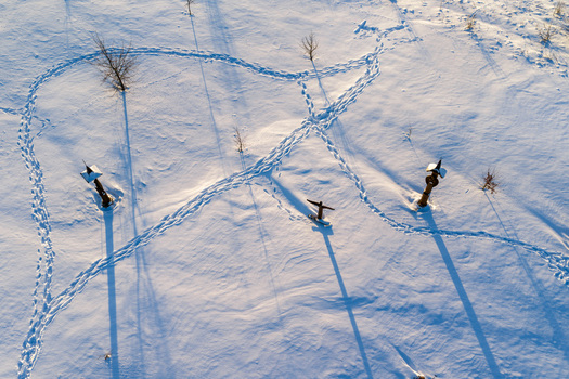 Aerial view of the Hill of Angels featuring wooden sculptures and long shadows on a snow covered field in Traku rajonas Vilniaus apskritis Lithuania. Aerial view of the Hill of Angels featuring wooden sculptures and long shadows on a snow covered field in Traku rajonas Vilniaus apskritis Lithuania.