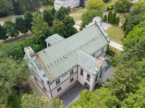 Aerial view of the historic Tihanyi Mansion now a museum surrounded by lush green trees and parkland in Banska Bystrica Banskobystricky kraj Slovakia. Aerial view of the historic Tihanyi Mansion now a museum surrounded by lush green trees and parkland in Banska Bystrica Banskobystricky kraj Slovakia.