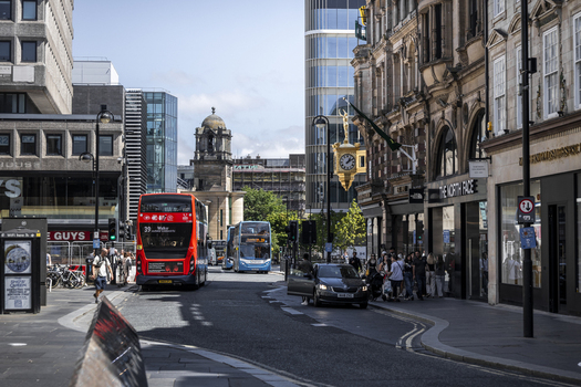 Newcastle upon Tyne England United Kingdom 13 July 2026 View of Grainger Street with a red double decker bus historic clock and pedestrians on the sidewalk. Newcastle upon Tyne England United Kingdom 13 July 2026 View of Grainger Street with a red double decker bus historic clock and pedestrians on the sidewalk.