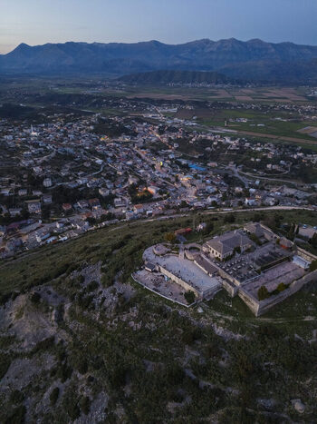Aerial view of Lekuresi Castle overlooking the town of Saranda with its historic stone walls and panoramic coastal landscape at twilight in Saranda Vlore County Albania. Aerial view of Lekuresi Castle overlooking the town of Saranda with its historic stone walls and panoramic coastal landscape at twilight in Saranda Vlore County Albania.