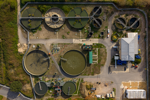 Aerial view of Ashford Common Water Treatment Works with circular sedimentation tanks filtration basins and industrial infrastructure in Shepperton England United Kingdom. Aerial view of Ashford Common Water Treatment Works with circular sedimentation tanks filtration basins and industrial infrastructure in Shepperton England United Kingdom.