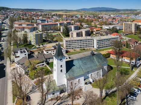 Aerial view of the Roman Catholic Church of Saints Simon and Jude with its white tower and green roof surrounded by urban buildings and green trees Namestovo Zilina Region Slovakia. Aerial view of the Roman Catholic Church of Saints Simon and Jude with its white tower and green roof surrounded by urban buildings and green trees Namestovo Zilina Region Slovakia.