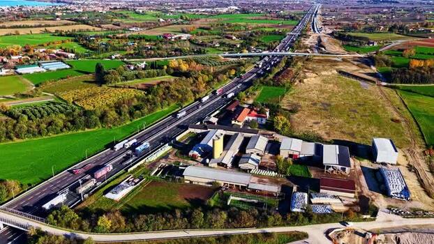 Aerial view of highway and rural landscape in Italy.