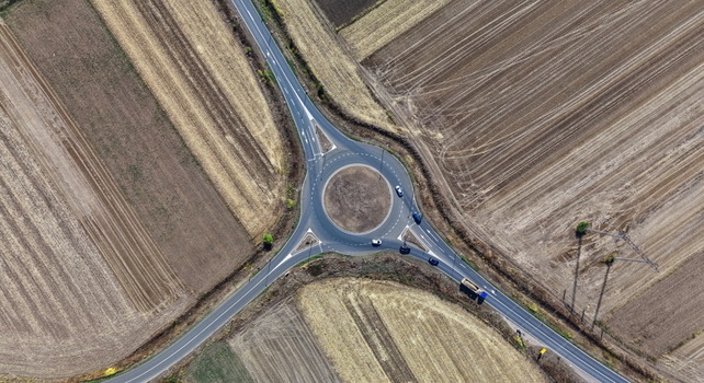 Aerial view of a roundabout surrounded by agricultural fields in the rural landscape of Bavaniste Vojvodina Serbia.