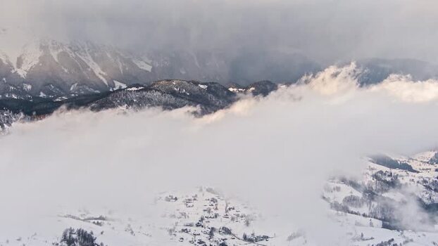 Aerial view of snowy Pestera village in the mountains Romania.